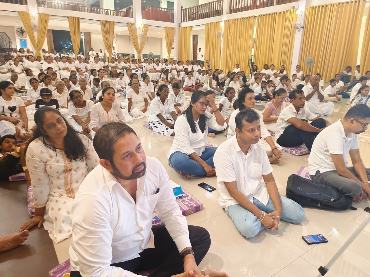 The community gathered in the hall for a Dhamma sermon
